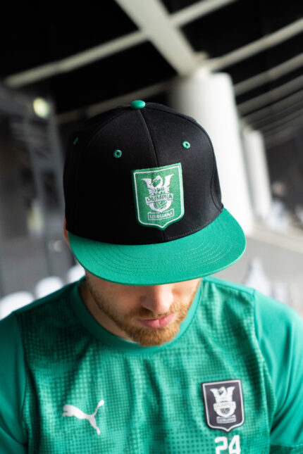Kapa s šiltom - grb Olimpija